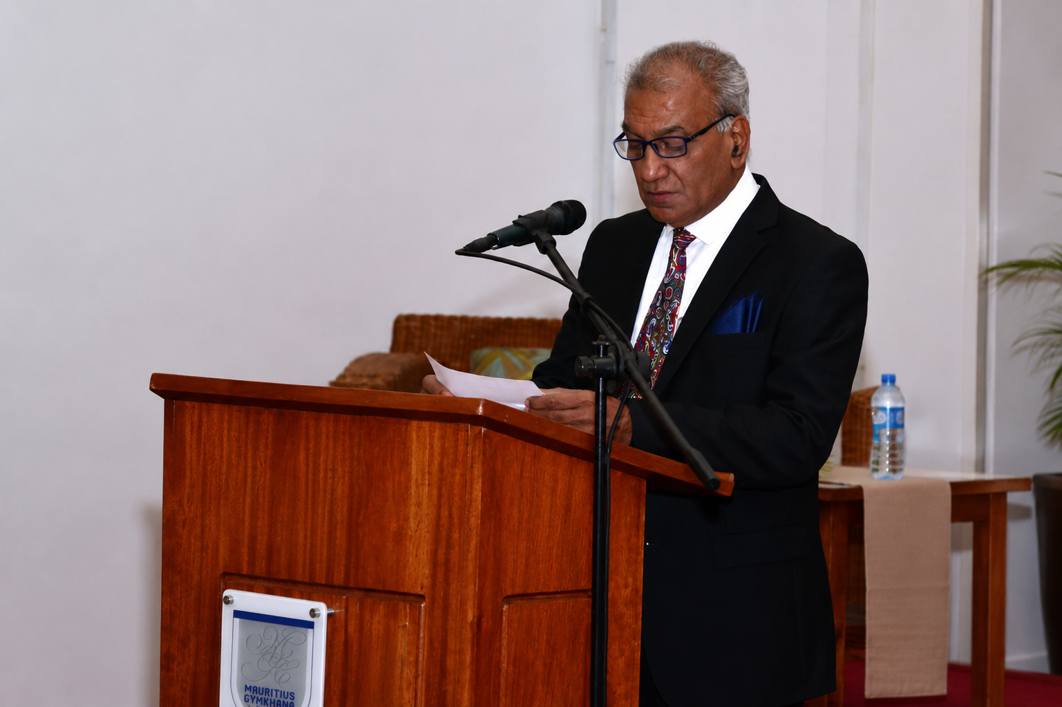 Speaker reading from notes at the lectern during the book launch